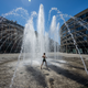 A child playing in a water fountain